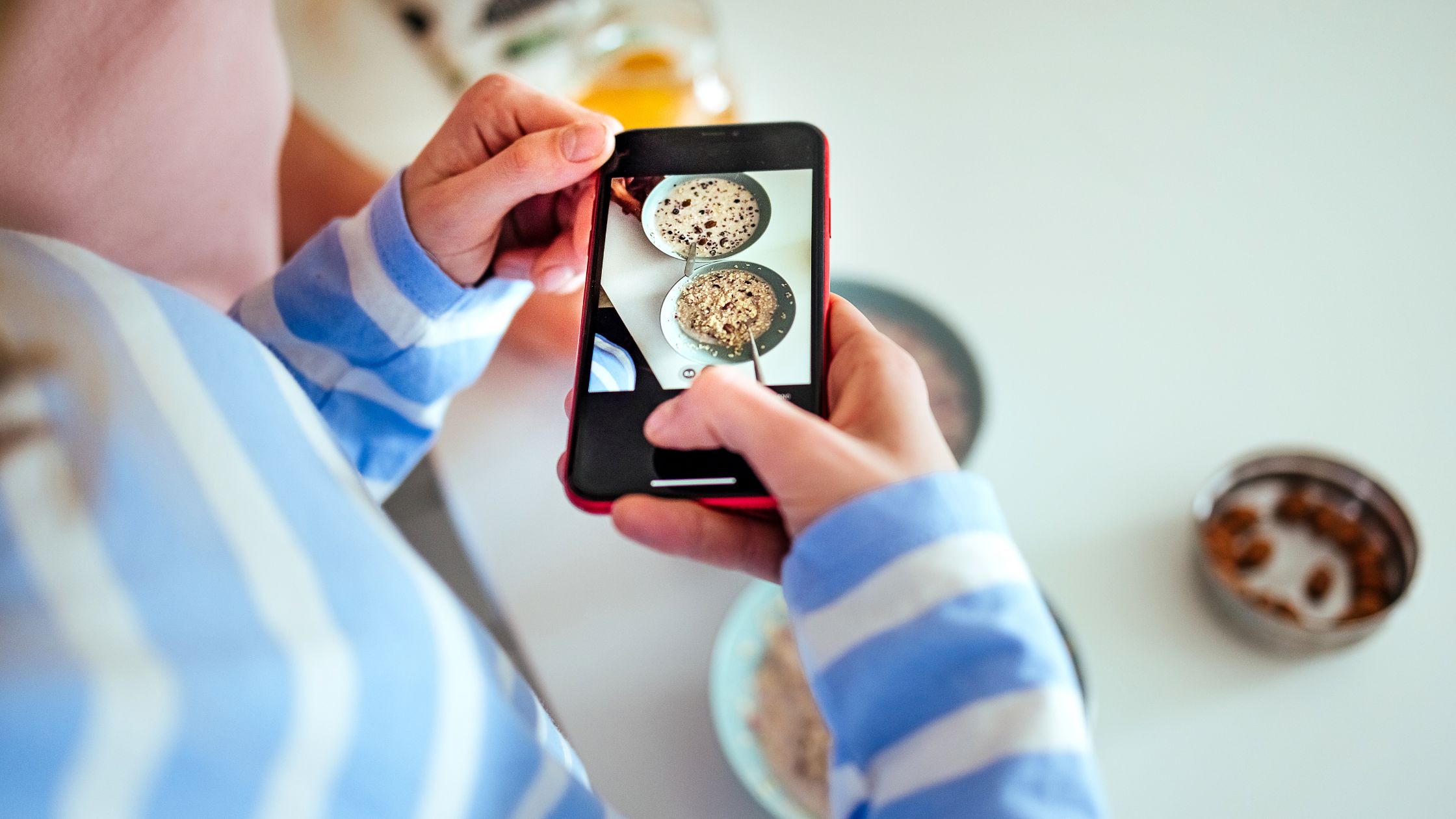 Woman taking photo of breakfast for an Instagram Story